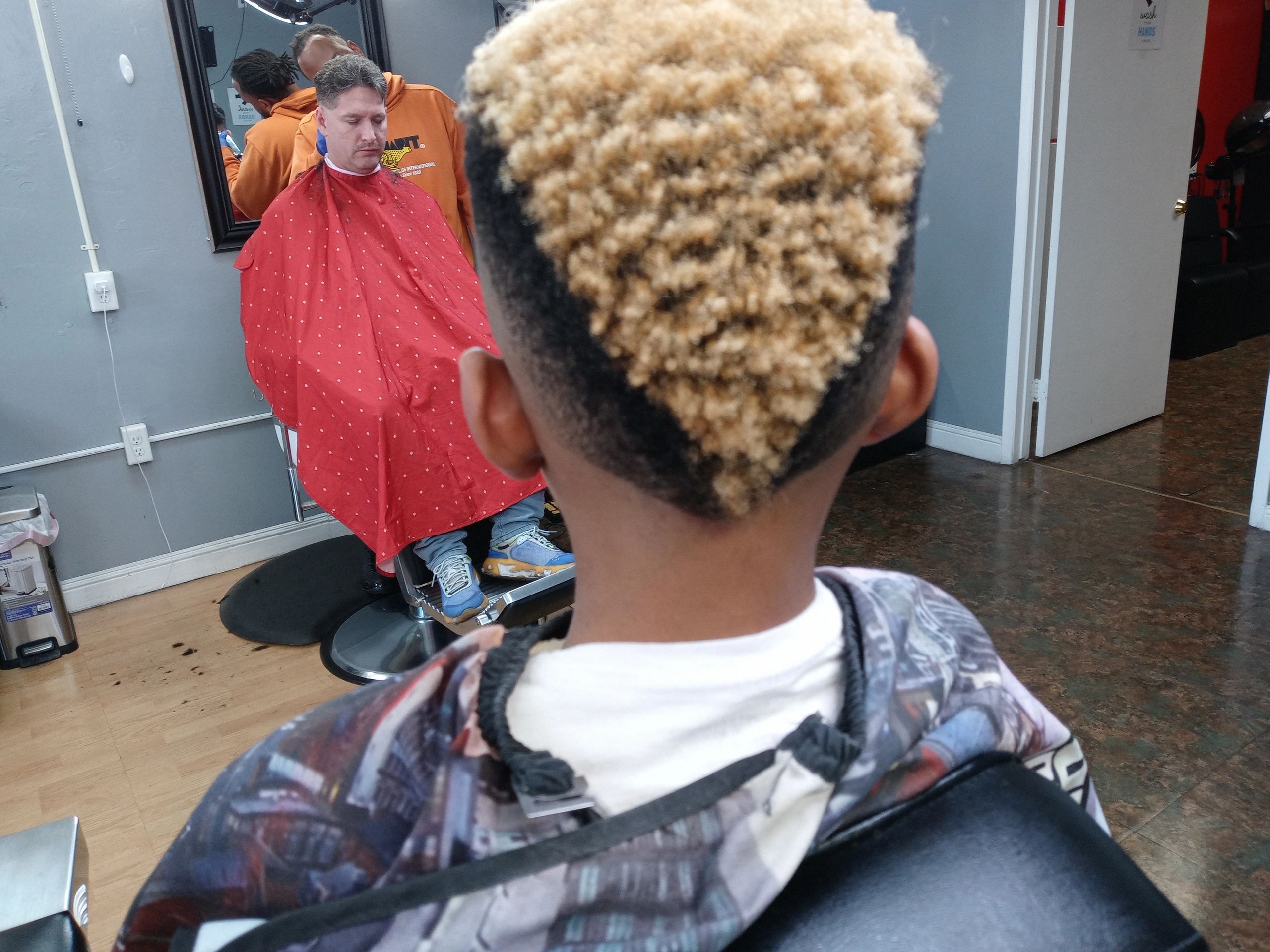 JW Barbershop barber giving a young client a professional haircut in Lancaster CA