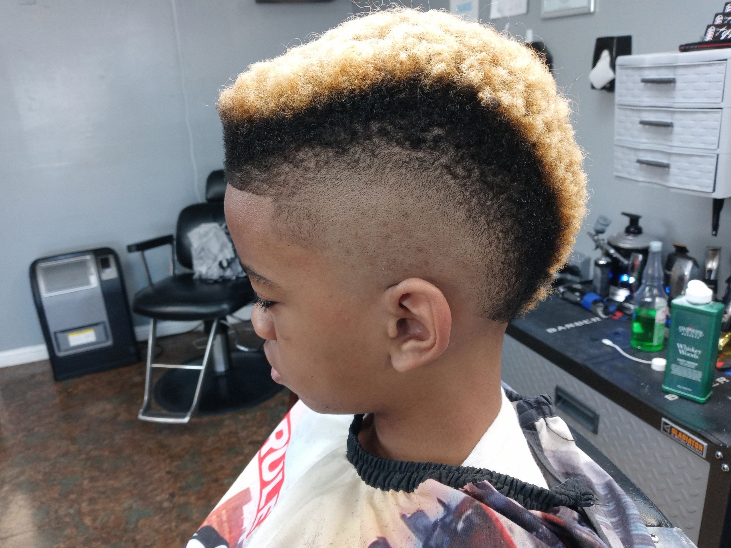 Man with a two-tone blonde and dark fade haircut showing barbershop craftsmanship