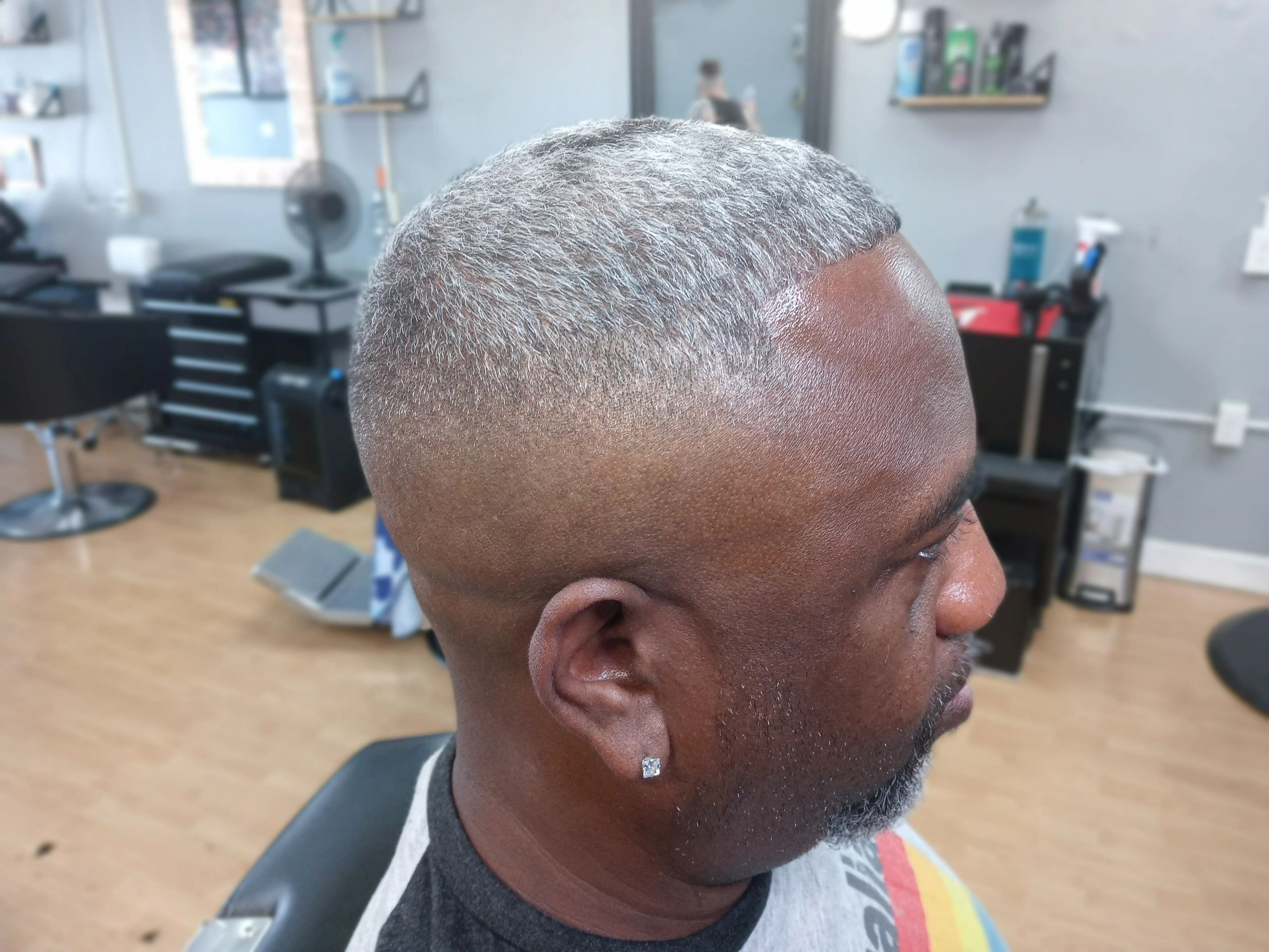 Man with a fresh low fade haircut showing clean lines at JW Barbershop
