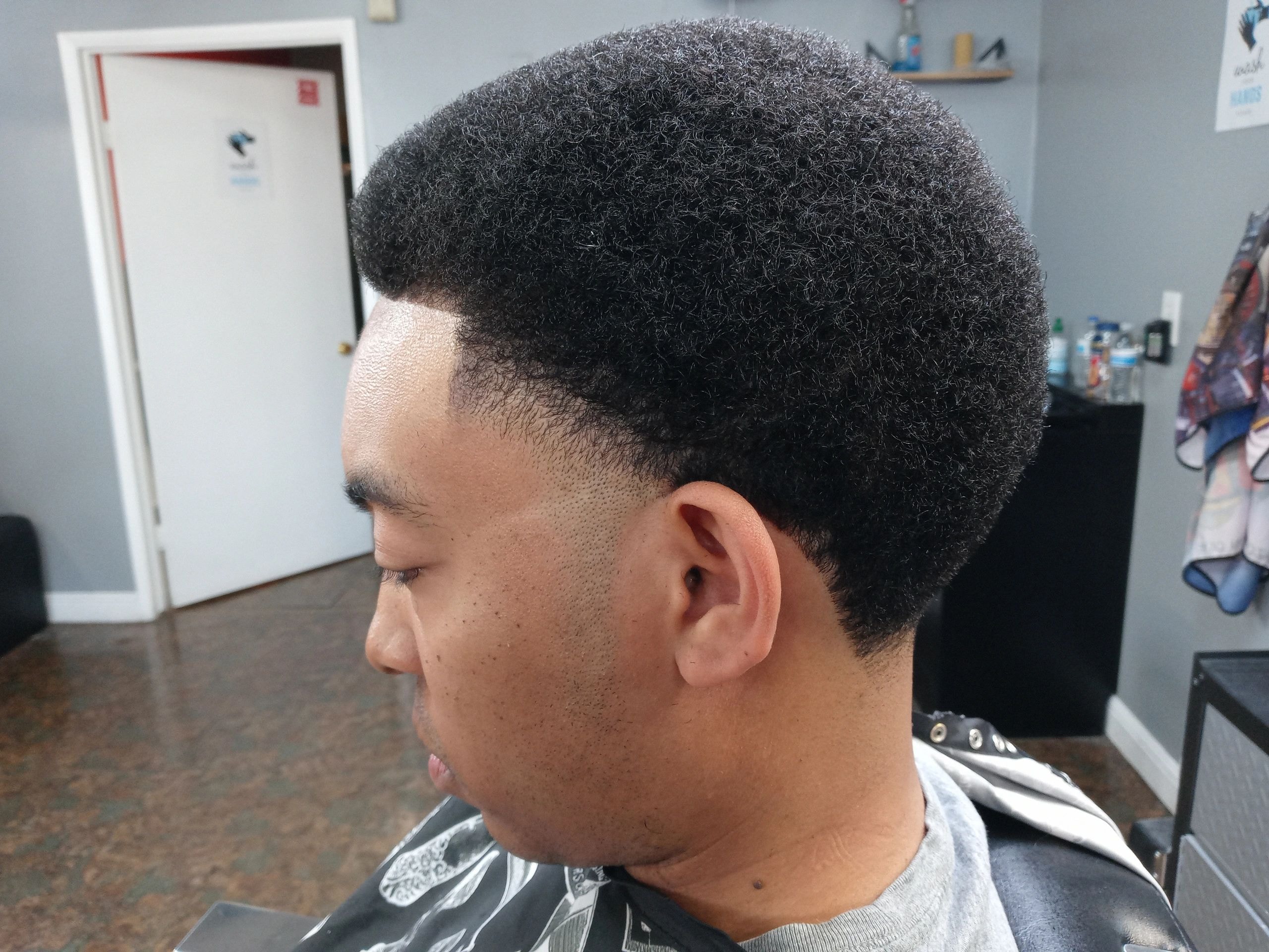 Man with a high skin fade haircut profile view at JW Barbershop Lancaster