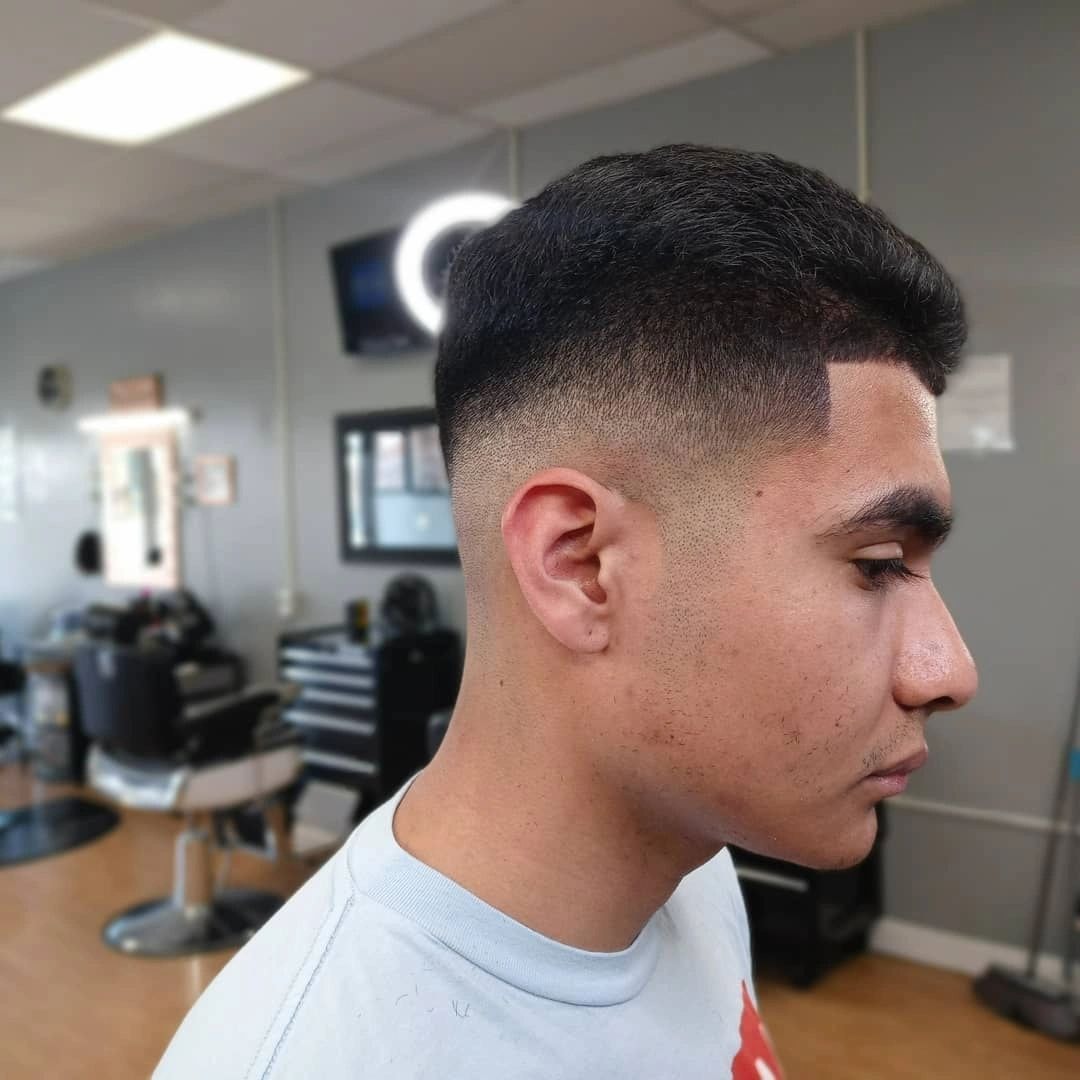 Man with a clean fade undercut haircut at JW Barbershop Lancaster CA
